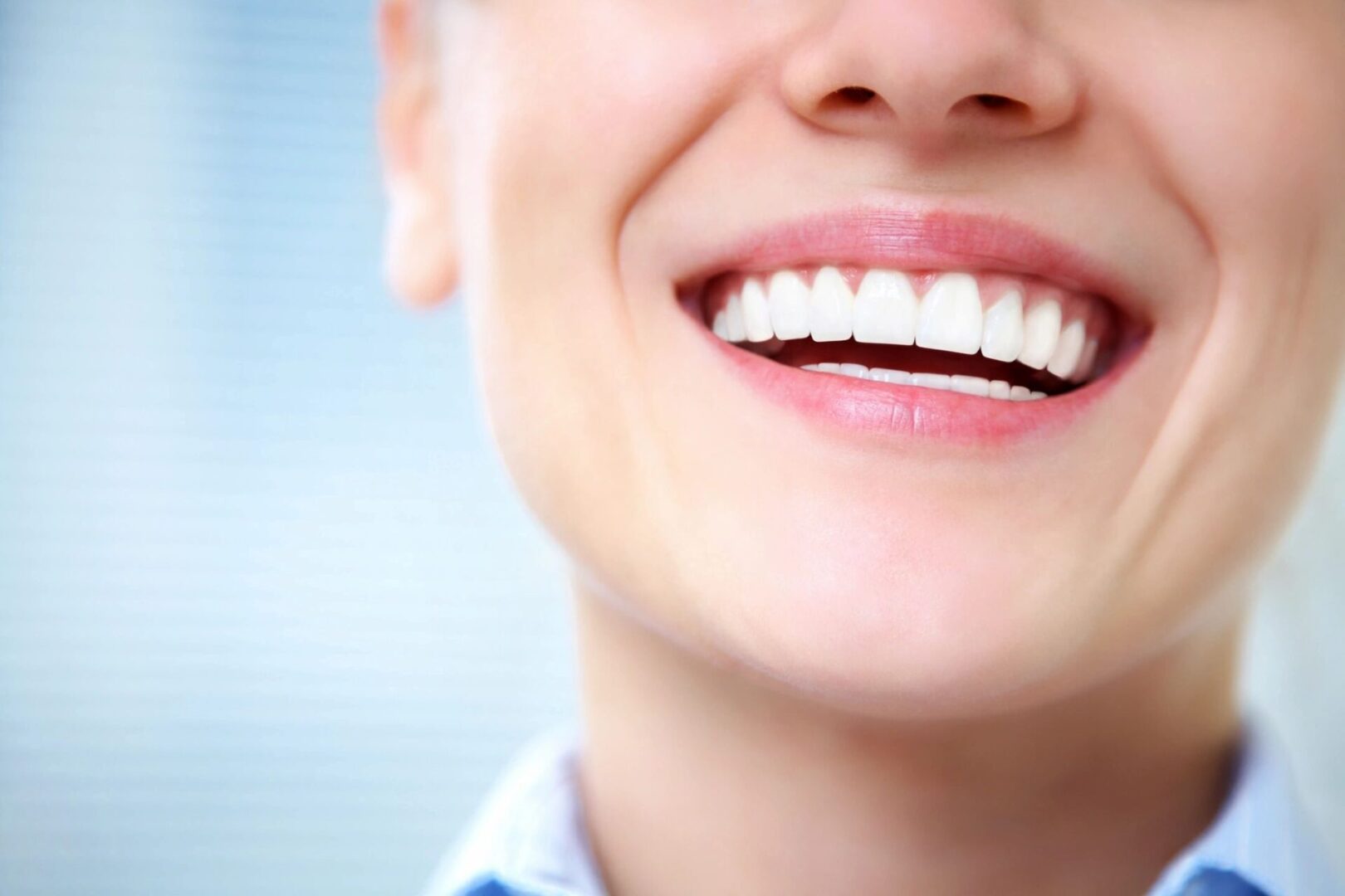A close up of a person 's smile with white teeth.